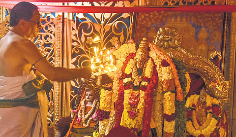 A priest offers Harati to Goddess Kanaka Durga Devi atop the Indrakeeladri on the first day of Dasara festivities in Vijayawada on Sunday. Devotees throng the Durga temple; artistes take part in cultural programmes