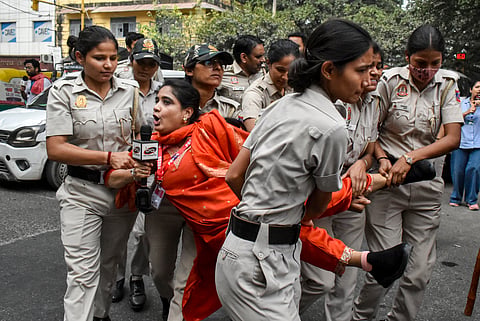  Police personnel detain protestors amid continued demonstration calls by the Cockroach Janta Party (CJP) demanding the resignation of Chief Election Commissioner (CEC) Gyanesh Kumar, in the RK Ashram area, New Delhi, Sunday, Oct. 11, 2026.