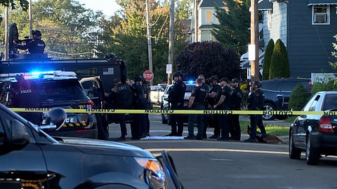 In this image from video provided by WJET, police gather outside the scene of a shooting in Erie, Pa., on Friday evening, Oct. 9, 2026. 