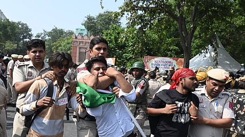 Security personnel detain protesters from various organisations as a protest is called by CJP against the Election Commission of India in New Delhi on Saturday. 