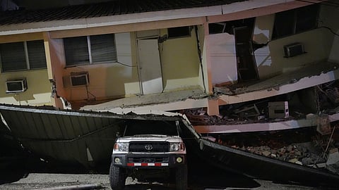 A vehicle lies crushed beneath a collapsed building after an earthquake struck Penonome, Panama, Friday, Oct. 9, 2026.
