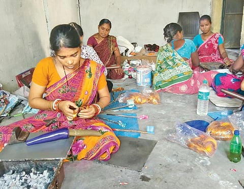 Members of Binapani Lacquer Producer Group engaged in making lacquer bangles 