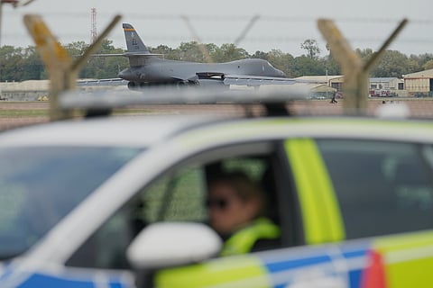 FILE - A B1 bomber prepares to take off as police officers guard a checkpoint near RAF Fairford air base, in Fairford, England, Tuesday, Sept. 29, 2026