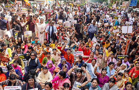 BJP Mahila Morcha members hold placards as they stage a protest outside Congress headquarters, in New Delhi, Monday, Oct. 12, 2026.