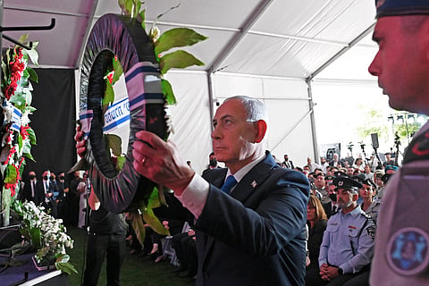 Israeli Prime Minister Benjamin Netanyahu lays a wreath during the state memorial ceremony for the third anniversary of October 7 attack, at Mount Herzl military cemetery in Jerusalem on October 5, 2026.