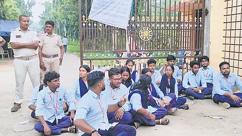 Students sitting on dharna at SVM Autonomous College on Monday.