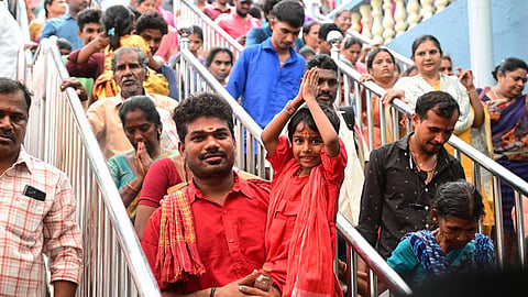 Devotees wait in queue to offer prayers at the Sri Durga Malleswara Swamyvarla Devasthanam atop Indrakeeladri in Vijayawada on Monday.