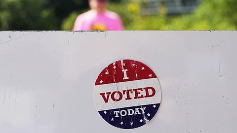 An, " I Voted Today," sticker is stuck to an information sign at Olbrich Gardens, Aug. 11, 2026, in Madison, Wis.