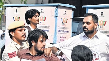 Police personnel detain members of student organisations.