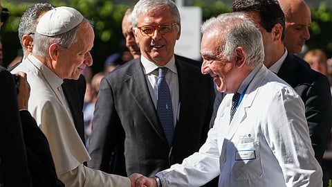 Medical Director Andrea Cambieri, right, greets Pope Leo XIV as he arrives at the Agostino Gemelli Polyclinic in Rome on Tuesday, Oct. 13, 2026, where doctors expect to operate to remove a lung nodule.