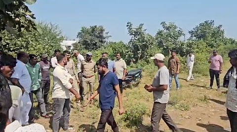 Family member and officials at the spot where the victims body was found.