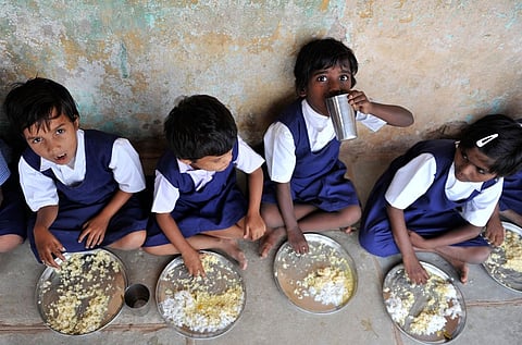 Schoolchildren having the meal served as part of PM-POSHAN, formerly Mid-day meal scheme, at a government primary school 