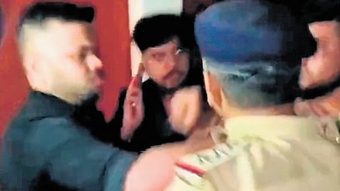 A video that has gone viral shows a police inspector questioning Vikas, even as the latter’s friend manhandles the officer and threatens him.