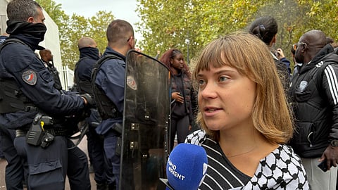 Activist Greta Thunberg answers journalists' questions as she attends a gathering in front of the Paul Eluard High School during a protest against under-resourced schools in Saint-Denis, outside Paris, Tuesday, Oct. 13, 2026.