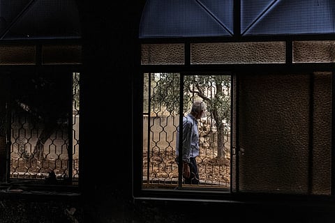 A Palestinian man assesses the damage at a mosque following a reported arson attack by Israeli settlers in Mikhmas, in the Israeli-occupied West Bank, on October 14, 2026.