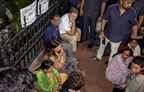  Lok Sabha Leader of Opposition (LoP) Rahul Gandhi sits with the parents of Ankita Bhandari during a sit-in protest at India Gate, in New Delhi, Wednesday, Oct. 14, 2026.
