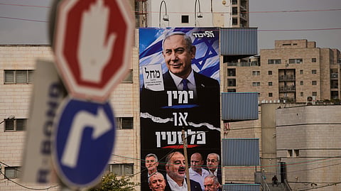 A Likud party campaign billboard depicting Israeli Prime Minister Benjamin Netanyahu alongside opposition party leaders and bearing the Hebrew slogan "Right or Palestine", ahead of Israel's general election in Jerusalem, Tuesday, Oct. 13, 2026.