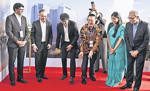 CM Vijay & Singapore Deputy PM Gan Kim Yong roll pineapples, a Singaporean custom believed to usher in good luck & prosperity, during the inauguration 