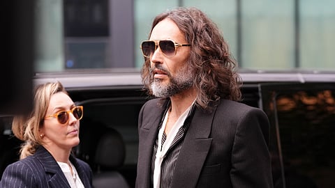 Russell Brand arrives at Southwark Crown Court, London, Wednesday, Oct. 14, 2026, where he faces three charges of rape, indecent assault, and sexual assault.