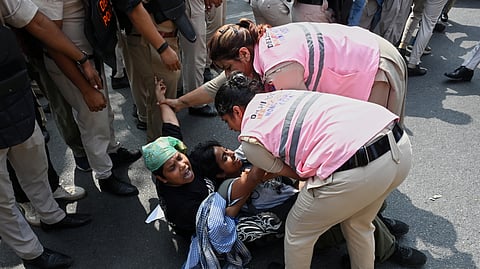 Police personnel detain protesters during a youth demonstration demanding the resignation of the country's election chief, Gyanesh Kumar, in New Delhi, India, Saturday, Oct. 10, 2026.