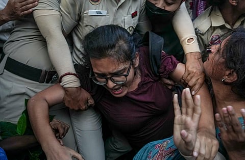 AISA chief Neha Bora being detained by the police during a protest against Chief Election Commissioner (CEC) Gyanesh Kumar, demanding his resignation over alleged irregularities in the Special Intensive Revision (SIR) of electoral rolls, at Mandi House, in New Delhi, Friday, Oct. 16, 2026.