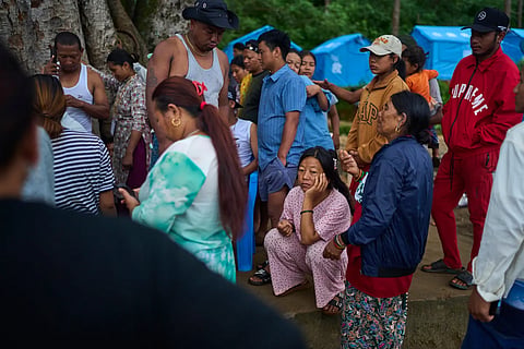 Survivors of the flash floods in Nepal in August this year wait to receive clothing for their children at a temporary holding center in Nepal's Nuwakot district, Sept. 23, 2026.