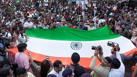 People participate in the 'Lehra Do Tiranga' protest march called by called by the Cockroach Janta Party (CJP) demanding the resignation of Chief Election Commissioner (CEC) Gyanesh Kumar over alleged irregularities in the Special Intensive Revision (SIR) of electoral rolls, at Connaught Place, in New Delhi, Friday, Oct. 16, 2026. 