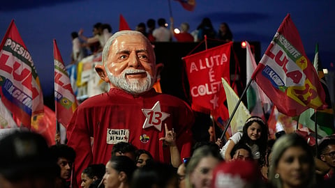 A supporter holds up a giant doll depicting Brazilian President Luiz Inacio Lula da Silva, who is running for reelection, during a rally ahead of the presidential runoff election in Brasilia, Brazil, Tuesday, Oct. 13, 2026.