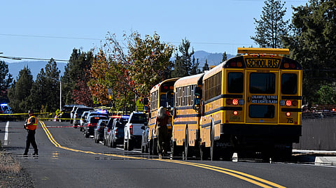 School buses are lined up outside Silver Rail Elementary school, where a shooting took place, on Thursday, Oct. 15, 2026 in Bend, Ore.