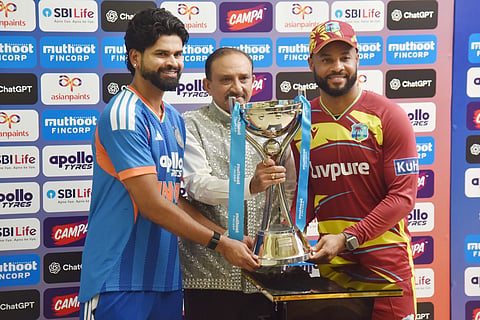 Captains Shreyas Iyer (India, L) and Shai Hope (West Indies, R) receive the series trophy from BCCI Treasurer Raghuram Bhat (C)