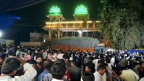 Police gather at the site after thirteen persons were killed and nearly 40 others suffered injuries when a truck crashed into several devotees waiting near a temple, in Madhya Pradesh's Gwalior city, Sunday, Oct. 18, 2026. 