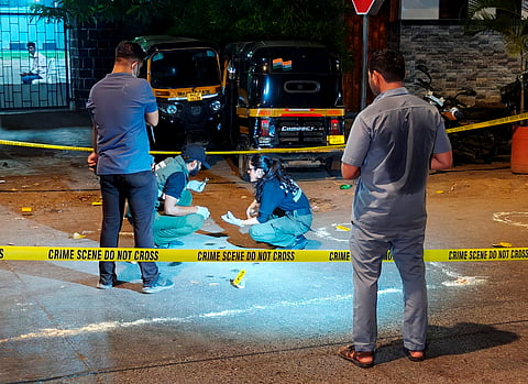 Police and forensic officials conduct investigation at the crime scene where gunmen opened fire at Bollywood actor Tiger Shroff, near Pushpa Park under Juhu police station, in Mumbai, Maharashtra, Sunday, Oct. 18, 2026. The actor escaped unhurt while his driver and another driver of an autorickshaw were injured in the incident, police said. 