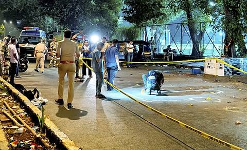 Police and forensic officials conduct investigation at the crime scene where gunmen opened fire at Bollywood actor Tiger Shroff, near Pushpa Park under Juhu police station, in Mumbai, Maharashtra, Sunday, Oct. 18, 2026. The actor escaped unhurt while his driver and another driver of an autorickshaw were injured in the incident, police said.