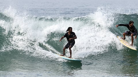 The surge of excitement and rigour of fun. Surfers at Varkala.