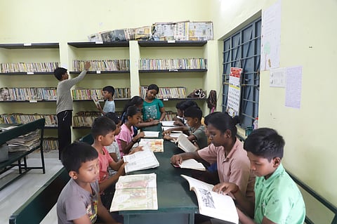 Children read books at the public library in Semmadu village near Coimbatore.