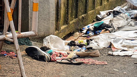 Footwear and other items lie scattered at the site after a stampede at Chor Bagan Durga Puja Pandal, in Kolkata on Sunday. 