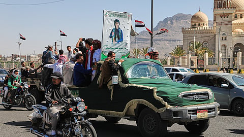 People ride in a pickup truck during a funeral procession for a Houthi officer in Sanaa, Yemen, Saturday, Oct. 17, 2026. The Arabic banner reads, "Martyr Mazen Abdallah."