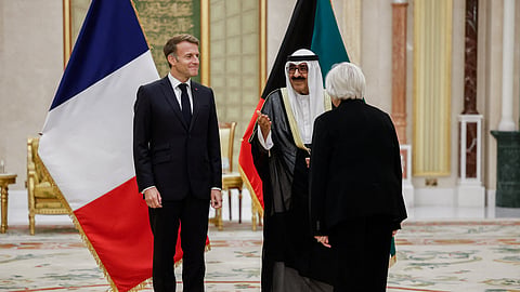 French President Emmanuel Macron (L) and Defense Minister Catherine Vautrin (back) meet with the Emir of Kuwait Sheikh Meshal Al-Ahmad Al-Jaber Al-Sabah (C), at Bayan Palace in Kuwait City on October 19, 2026.