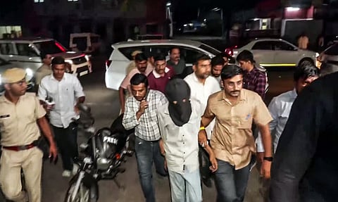 Accused being taken away from the residence of the judge in connection with the firing on Bollywood actor Tiger Shroff, in Kota on Monday.