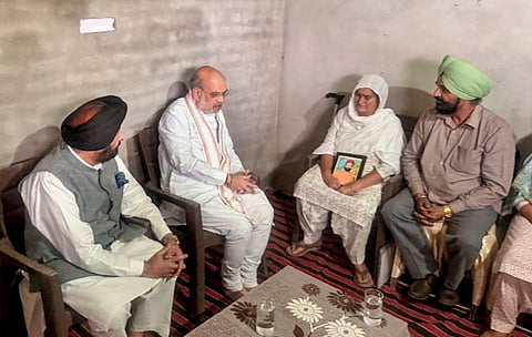 Union Home Minister Amit Shah meets the family members of late Vikramjit Singh, who allegedly lost his life after raising his voice against synthetic drug traders, in Gurdaspur, Punjab.