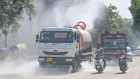 An anti-smog gun truck sprays water on a road near India Gate to curb dust pollution amid high vehicular traffic on Monday.