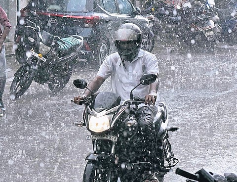 A commuter riding through the rain at Aminjikarai in Chennai on Tuesday 