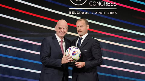 FILE - UEFA President Aleksander Ceferin, right, and FIFA president Gianni Infantino, left, holding a ball during the 49th UEFA congress in Belgrade, Serbia, April 3, 2025.