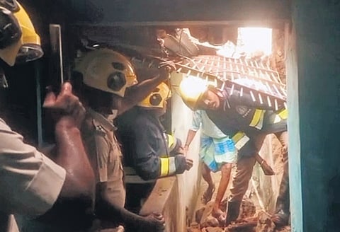Firefighters rescue the family trapped inside their house on Friday 