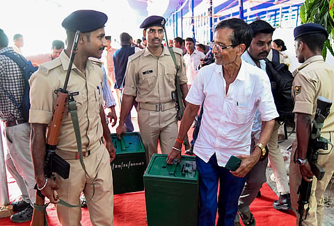An election official with electoral material for his booth in Patna on Thursday 