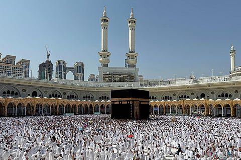 Pilgrims pray in front of the Kaaba, Islam's holiest shrine, at the Grand Mosque in the Muslim holy city of Mecca, Saudi Arabia, during the minor pilgrimage, known as Umrah, that can be undertaken at any time of the year, Friday, Oct. 23, 2026.