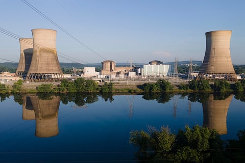 At Constellation's nuclear power plant on Three Mile Island, called the Crane Clean Energy Center, near Middletown, Pa., the cooling towers are reflected in the Susquehanna River, June 25, 2025. 