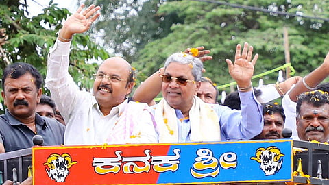 Minister Dr Yathindra Siddaramaiah and former CM Siddaramaiah during the inauguration of the renovated Dandi Maramma temple in Siddaramanahundi village in Mysuru on Friday.