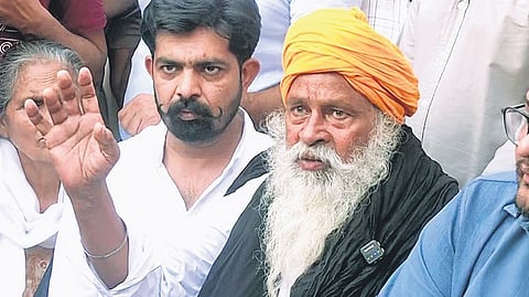 A file picture of anti-drug activist Jhota’s father sitting on a protest.