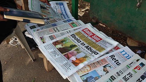 A man sells newspapers in Abuja, Nigeria Wednesday, Oct. 21, 2026.